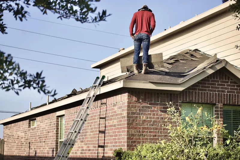 Professional roofer working on a residential roof in Shongum